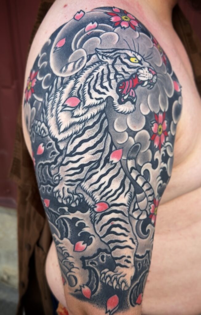 Japanese style tiger tattoo with cherry blossoms black and grey