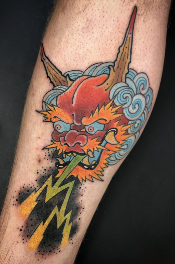 Japanese style oni devil mask tattoo lightning bright color