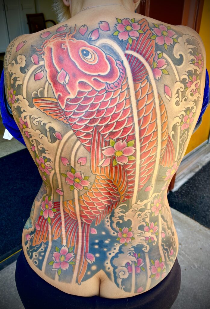 Traditional Japanese style back piece tattoo koi fish cherry blossoms color waves