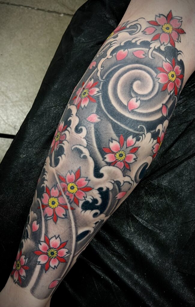 Japanese style water waves cherry blossoms leg tattoo